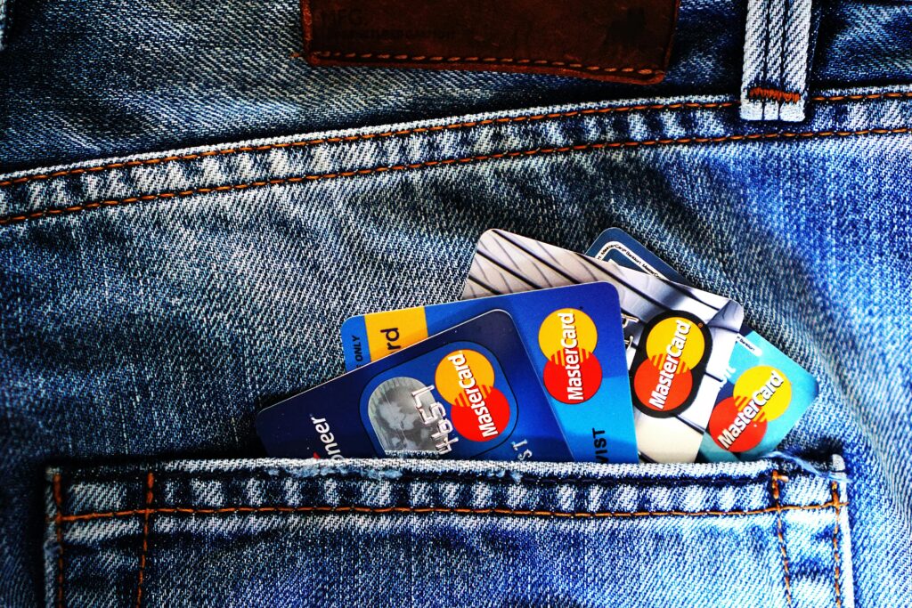 Protect your credit. Picture of credit cards hanging from the back pocket of a pair of jeans.